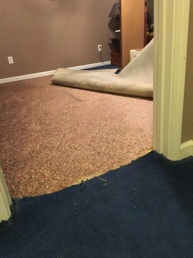 Carpet pad removal revealing water damage during Drying & Dehumidification in Granger